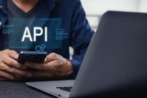 Developer Working on Mobile API Interface with Laptop and Phone photo