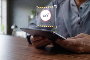 Monitoring Carbon Dioxide Levels with Digital Device in Modern Workspace photo
