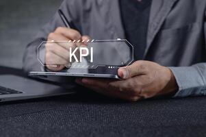 Business Professional Analyzing Key Performance Indicators on Laptop photo