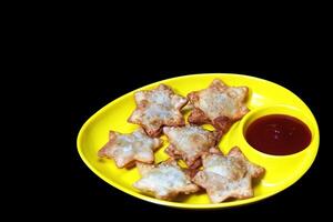 Golden Star Aloo Puff Pastries with Tangy Tomato Sauce on Elegant Black Marble - A Luxurious Treat for Parties and Tea-Time photo