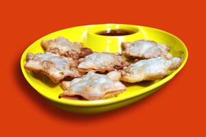 Golden Starry Aloo Puff Pastries with Rich Tomato Dip on Black Marble - A Luxurious Bite for Tea-Time and Festive Celebrations, Isolated on Red BG photo
