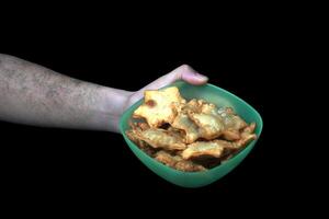 Golden Star-Shaped Aloo Puff Pastry Served with Zesty Tomato Sauce on a Chic Black Marble Plate in Hand - A Perfect Blend of Flavors for Parties and Afternoon Tea photo