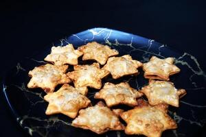Crisp and Golden Aloo Puff Stars on Elegant Black Marble - A Feast Fit for Festivities photo