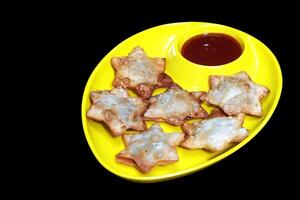 Flaky Star-Shaped Aloo Puff Pastry with Bold Tomato Dip on Sleek Black Marble - A Gourmet Delight for Festive Gatherings photo