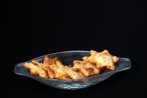 A clear glass bowl brimming with golden fried chicken wings, highlighting their crispy skin and savory appeal. photo