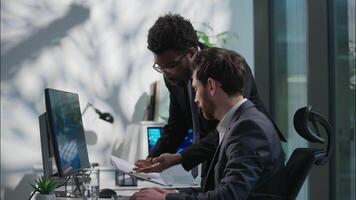 Annoyed African American leader dissatisfied boss scolding arguing Caucasian office worker businessman wrong failed project computer business men males problem conflict director swear employee mistake video