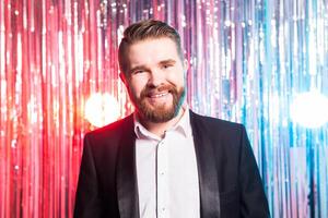 Party and holidays - Portrait of elegant handsome man in a expensive suit on shiny background. photo