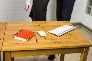 Office workplace with notebook, keyword and computer mouse on wood table photo