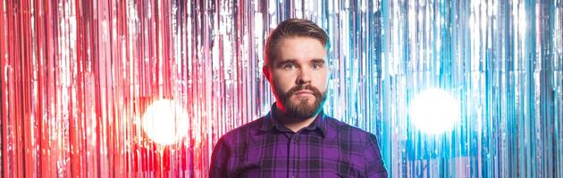 Club party and holidays - Portrait of handsome funny guy on shiny background. photo