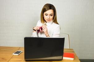 Portrait young shocked business woman sitting in front of laptop computer looking at screen. Funny face expression emotion feelings problem perception reaction. photo