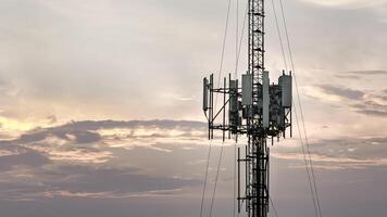 Telecommunication tower with antenna and transmitter for cellular signal, wireless network, and data connection. Infrastructure for high speed internet, and modern communication system photo