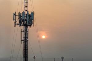 Telecommunication tower with antenna for wireless signal, internet, mobile network, digital connectivity, infrastructure, transmission, cellular technology, and global communication system. photo