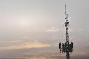 Telecommunication tower structure with mast and antenna, providing wireless signal, digital connection, cellular coverage, engineering, internet, high speed mobile data, network, and connectivity. photo