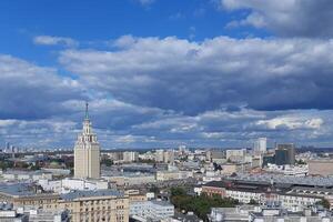 Moscow top view at the Komsomolskaya square, also known as the square of three railway stations. Stalin skyscraper at left. Spectacular blue sky with clouds. Russia. Copy space for text. photo