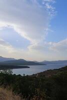 Sea landscape with mountains and clouds. Sunset. photo