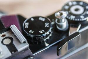 Old film camera, The wheel of choice shutter and shutter button, Close up view at 125 speed shutter, Selective focus, Vintage photo style