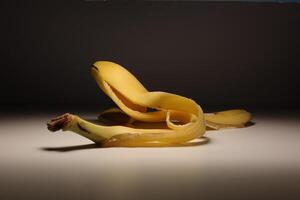 Single peeled banana on clean minimal background in studio lighting photo