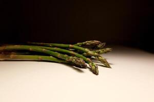 Fresh green asparagus spears on white background in studio lighting photo