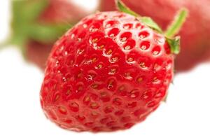 Strawberries in focus and defocused strawberry berries isolate on white. photo