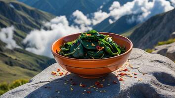 Spinach Bowl Garnished with Pepper Flakes Against Mountain View Background photo