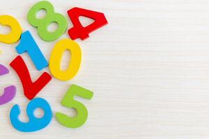 Wooden Numbers on Light Wood Background photo