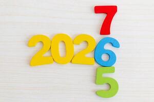 Wooden Numbers 2026 on Light Wood Background photo