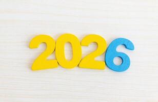 Colorful Wooden Numbers 2026 on Light Wood Background photo