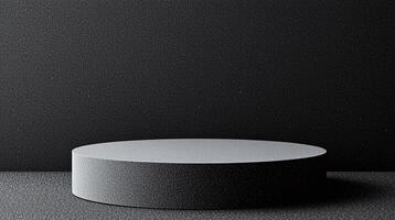 Round pedestal with black textured surface against dark background. photo