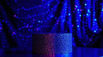 A cylinder with a glittering texture stands against a backdrop of blue and pink bokeh lights. photo