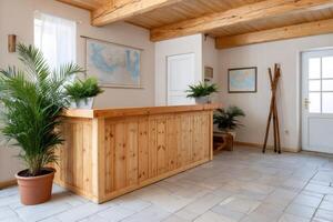 Wooden reception desk with plants and maps in a cozy hotel lobby photo