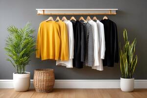 Casual clothes hanging on a rack, creating a stylish and minimalist wardrobe photo