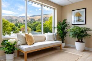 Waiting room with comfortable bench and large window overlooking green hills photo