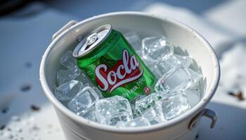 a soda can floating in a bucket of ice. photo