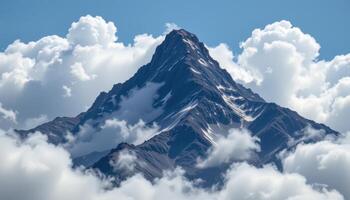 a jagged peak surrounded by swirling clouds. photo