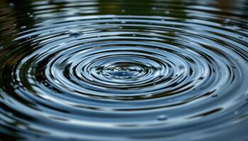 ripples in a still pool from falling rain. photo