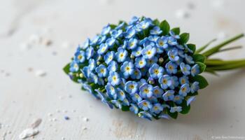 compact bouquet of forget me nots in a teardrop shape photo