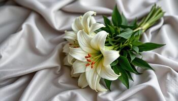 elegant white lily bouquet on silky pale gray cloth photo