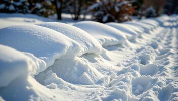 snowdrifts forming soft mounds along a fence line photo