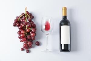 Flat lay composition with grapes, bottle and glass with wine, copy space photo
