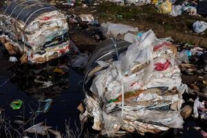 Large piles of plastic and mixed waste accumulate at a landfill, emphasizing the urgent need for better waste management practices photo