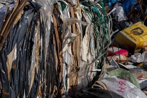 A landfill site showcases layers of compacted waste, highlighting the ongoing issues of pollution and the challenges in effective waste management photo