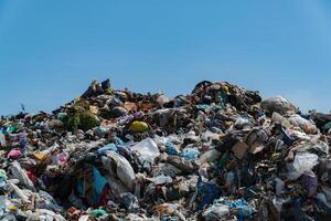 A massive landfill filled with heaps of plastic debris and garbage, showcasing the urgent need for effective waste management and recycling solutions photo