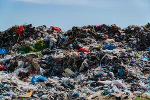Landfill filled with heaps of garbage, plastic waste, and debris severely impacting the surrounding environment and ecological balance photo