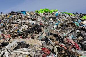 Large mound of mixed garbage and trash highlights the urgent need for improved waste management and recycling efforts in urban areas photo