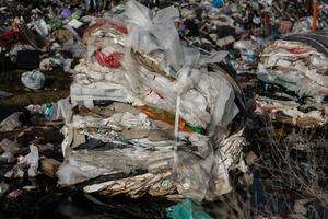 Layers of compacted trash are visible at a landfill site, highlighting the urgent need for better recycling and waste management practices photo