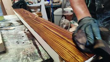 Protective Paint Is Applied To Wooden Planks In The Carpentry Shop Footage. video