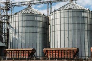 Two metallic silos stand tall at a grain storage facility, capturing the essence of agricultural harvest and efficient grain handling photo