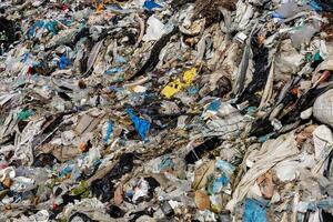 Garbage and plastic waste dominate the landfill, highlighting pollution's environmental impact and the need for improved sanitation photo