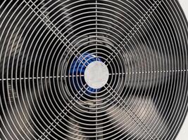 A detailed perspective of a metal fan, showcasing its spiral blades and center, designed for efficient airflow in a warm environment photo