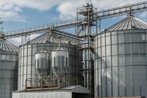 Steel silos and grain bins rise against a clear sky, symbolizing the importance of efficient grain storage in agribusiness and farming operations photo
